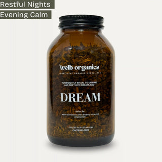 Sleep Tea infusion in a brown Welb Organics apothecary jar on a neutral background