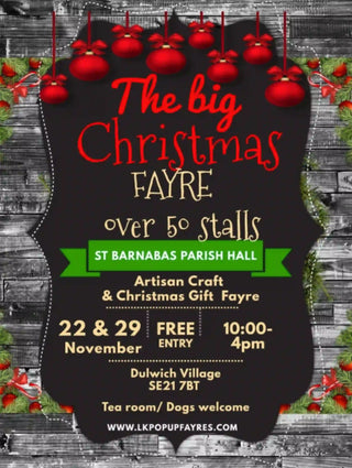 Advertisement for The big Christmas Fayre with festive decorations on a wooden background.