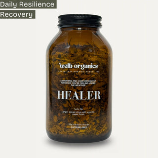 Brown bottle labeled 'Healer' by welb organics on a neutral background