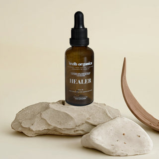 Bottle of 'Healer' on a stone surface with a neutral background