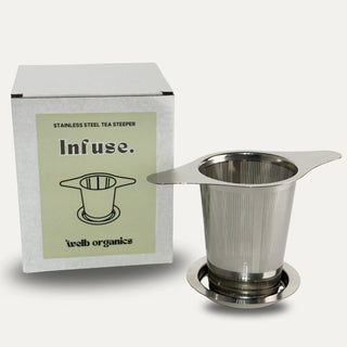 Stainless steel tea steeper with packaging labeled 'Infuse' on a neutral background