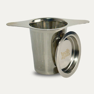 Stainless steel tea steeper on a neutral background