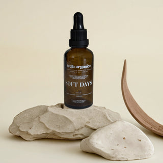 Brown glass bottle with dropper labeled 'Soft Days' on a light background